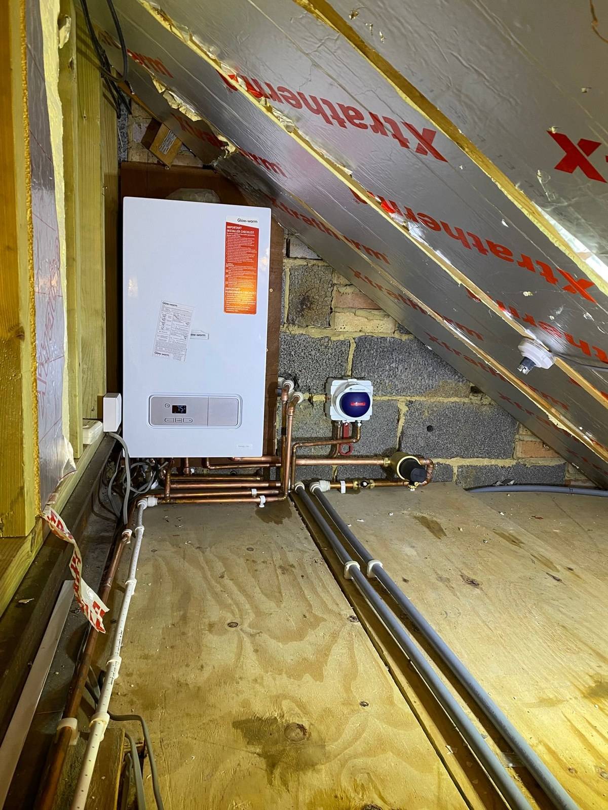 Boiler installed in a boarded loft in Tilehurst, Reading