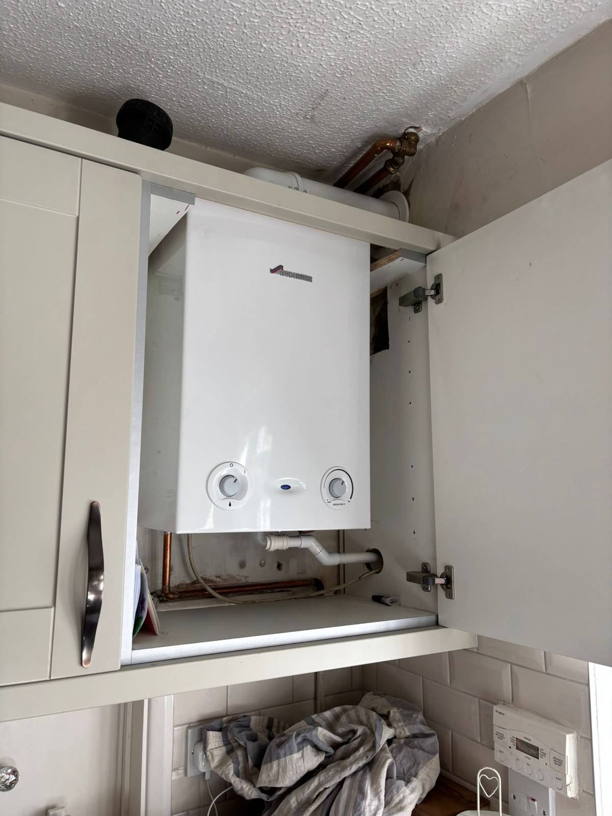 New Worcester Bosch boiler fitted in the same kitchen cupboard, Tilehurst