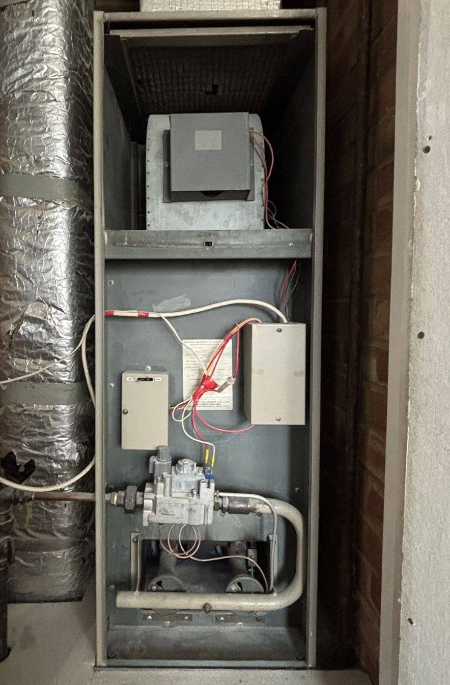 Warm air heating unit in an airing cupboard after a repair